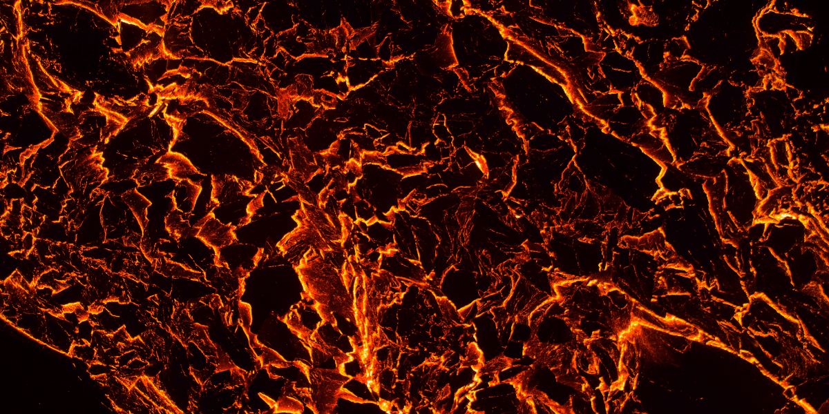 Abstract volcanic texture with glowing orange and black cracks resembling molten lava.