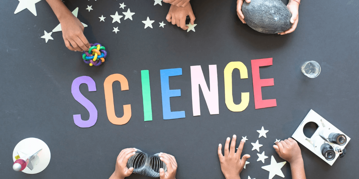Colorful letters spell "SCIENCE" surrounded by hands and various science-related objects and materials