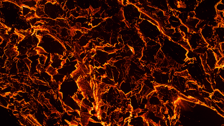 Abstract volcanic texture with glowing orange and black cracks resembling molten lava.